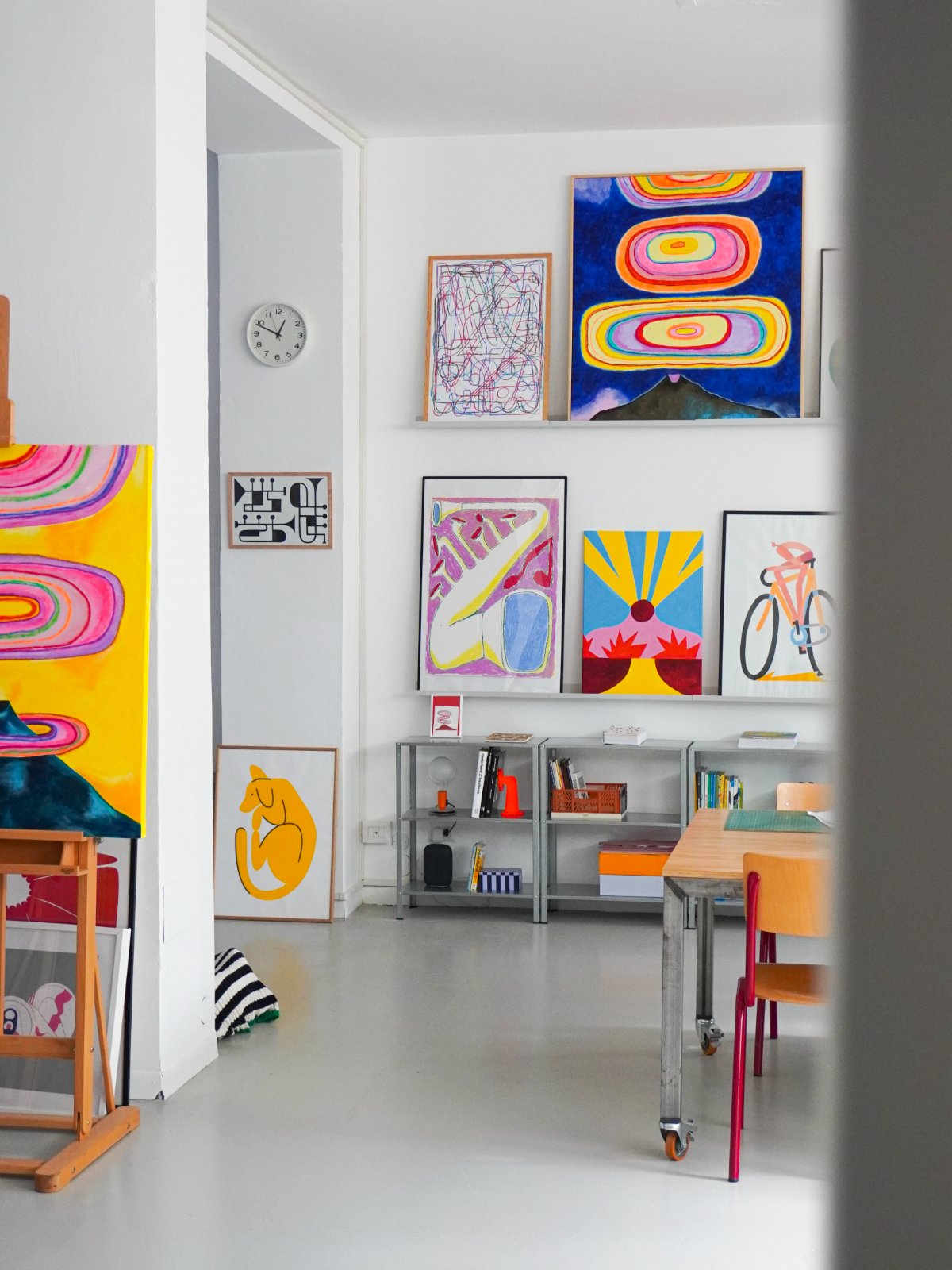 Paintings on the shelves and an easel